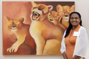 Dr. Sylisa Lambert-Woodard stands by Karen Free's artwork