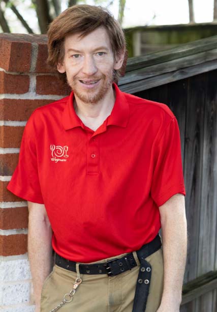 Nick K. smiles in his red shirt