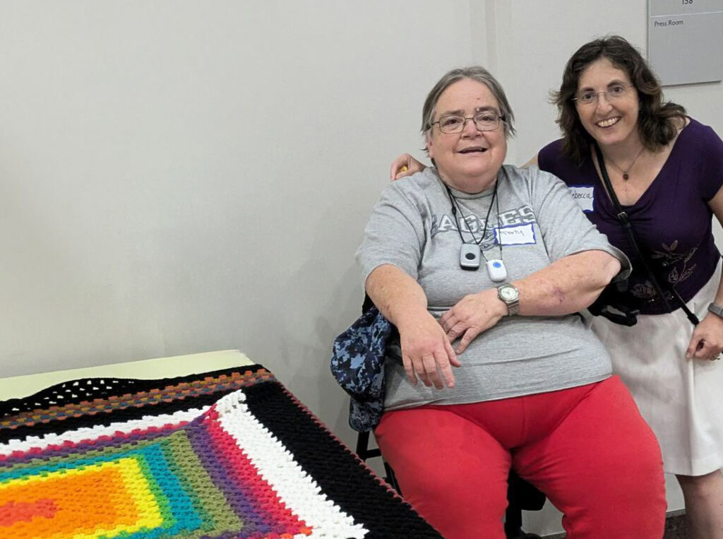 Marti Kelly with Rebecca Traeger who recently purchased her afghan at the Summer of the Arts Exhibit