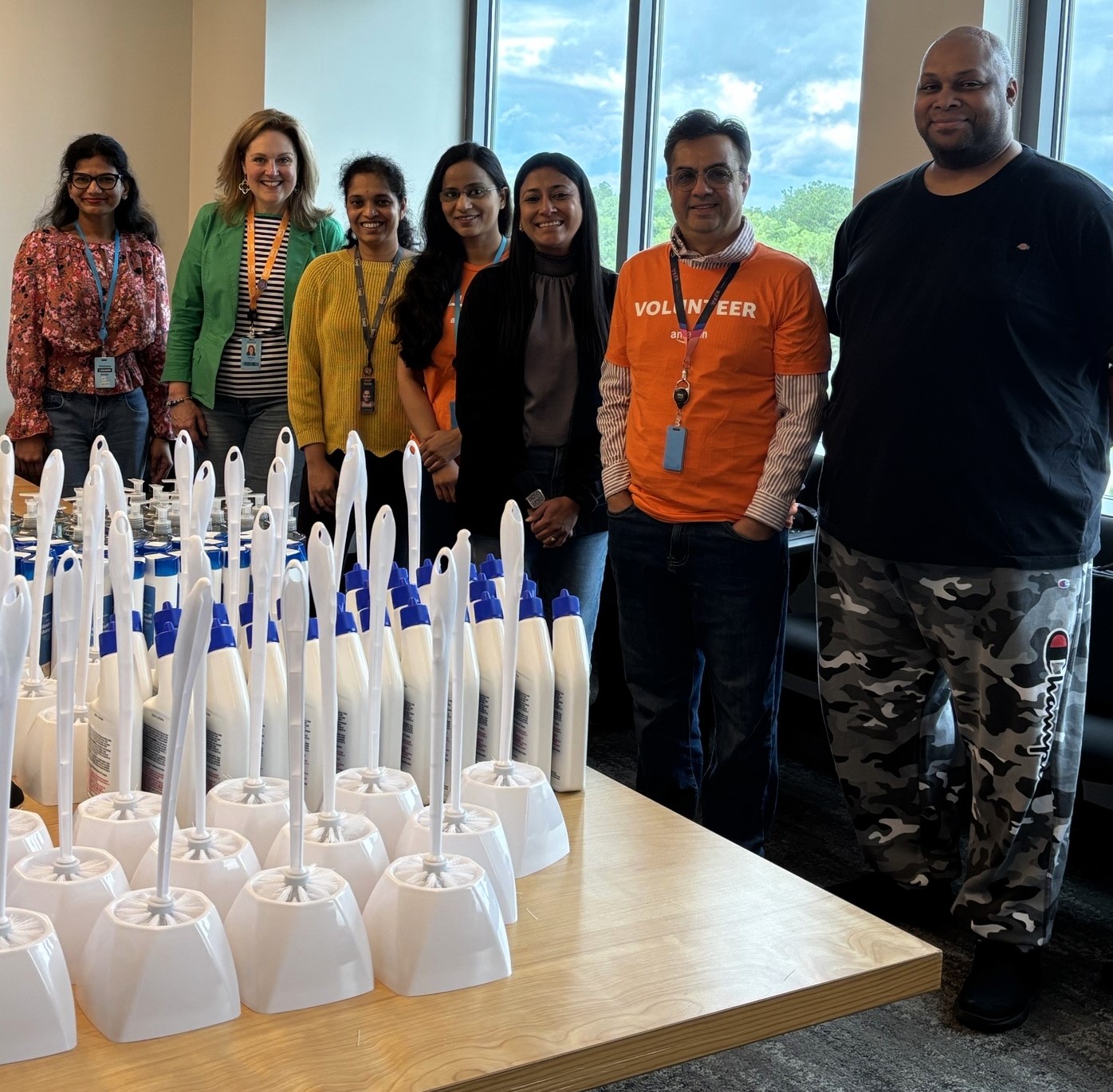 Amazon Web Services volunteers helping to put together welcome baskets with household supplies